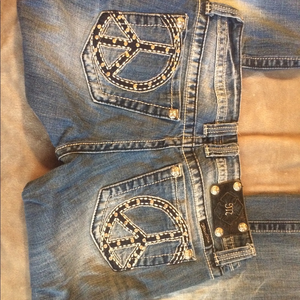 Distressed Miss Me jeans with peace sign